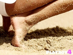 Cute blond hair lady mom psoing on the beach