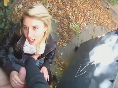 Adorable teenage girl sucking a dick in public