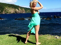 Gorgeous blonde Anikka Albrite posing among cloud-shrouded mountains