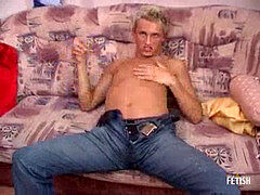 Horny blonde twink gets cum on stomach after sultry onanism on the couch