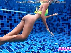Asian Girl Swims with Big Butt Plug