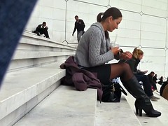 Sexy woman in black pantyhose sit on stairs
