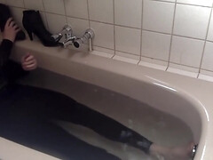 Sexy tight pants ankle boots and heels in bath