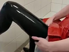 Dressing in red latex hooded swing dress and black rubber stockings